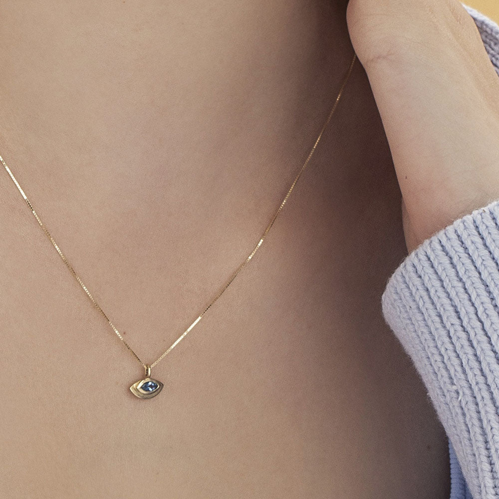 The evil eye pendant with a modern twist in aqua marine inlay