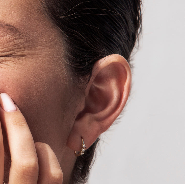 Small hoop earrings set with 3 diamonds
