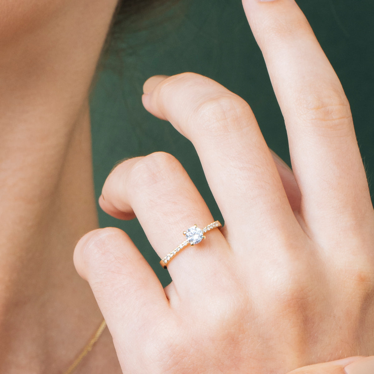 Solitaire gold ring set with a round diamond