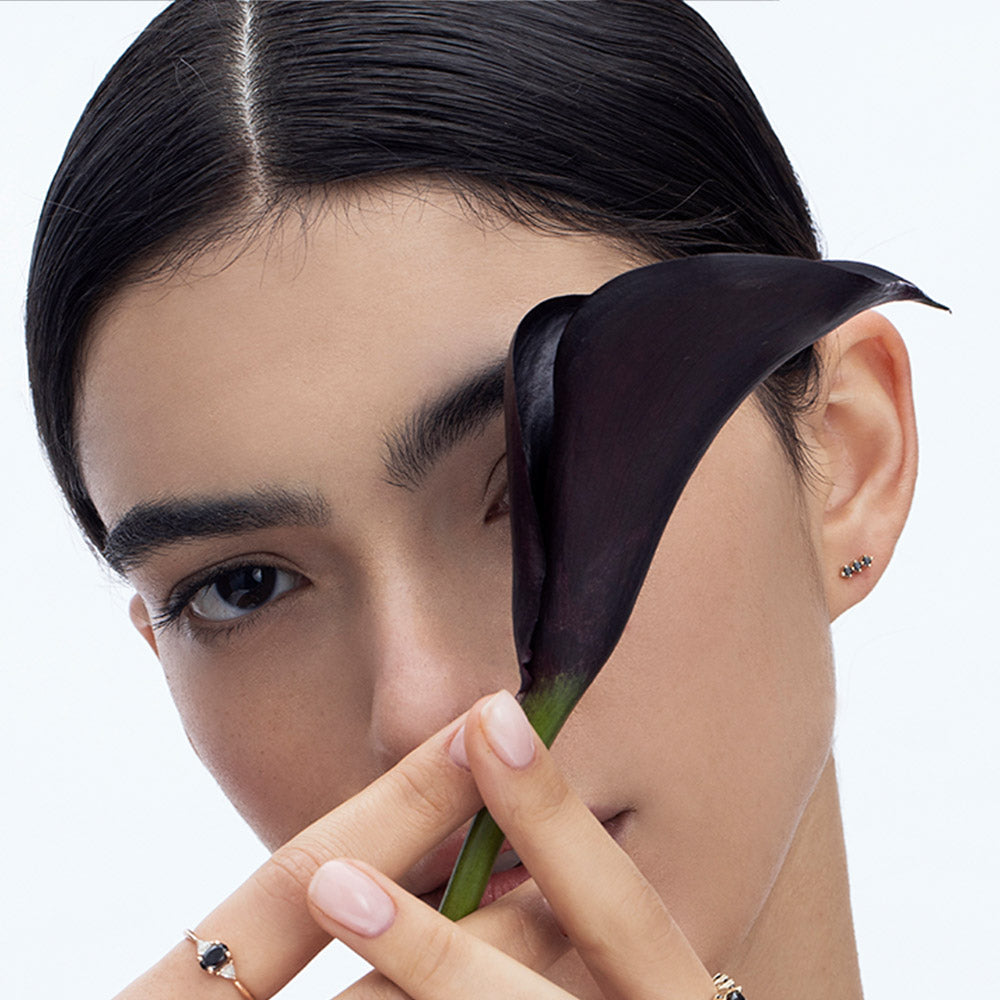 Tight gold earrings set with 3 black diamonds