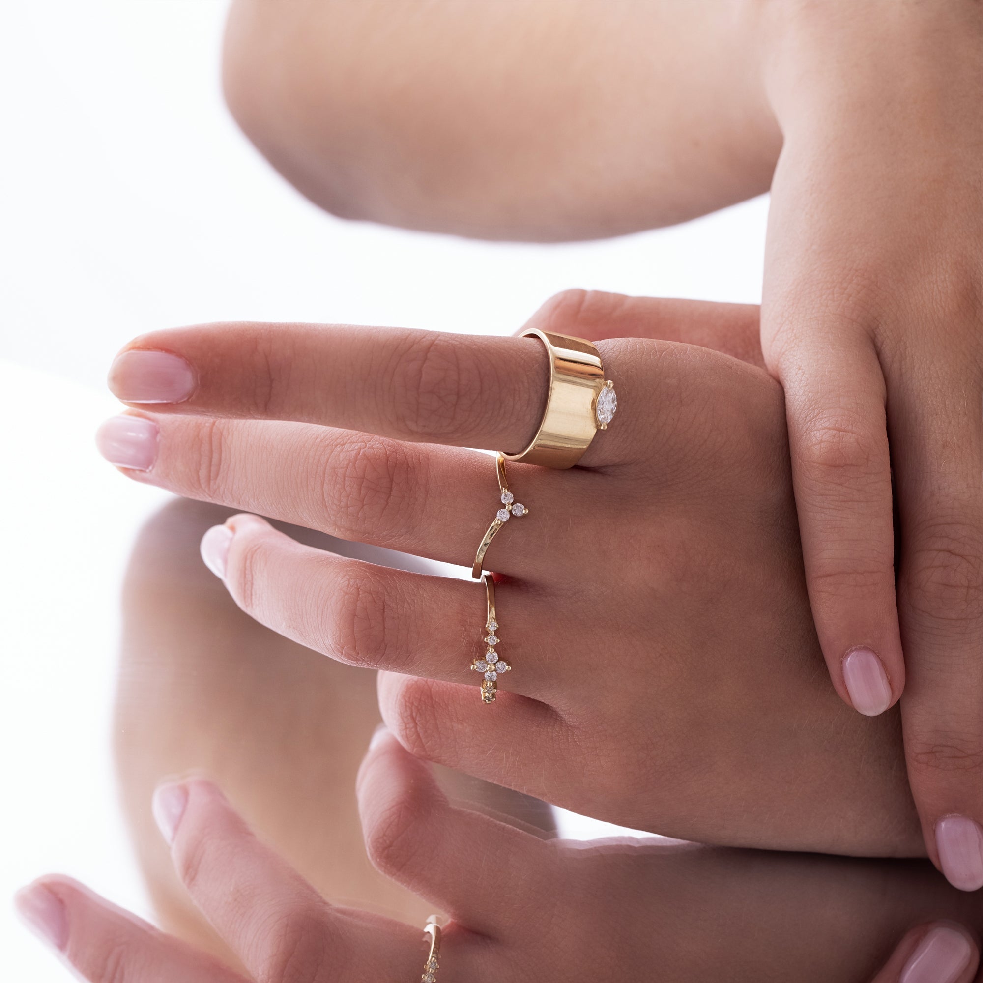 A delicate and rich gold ring studded with diamonds in the shape of a central flower and side diamonds