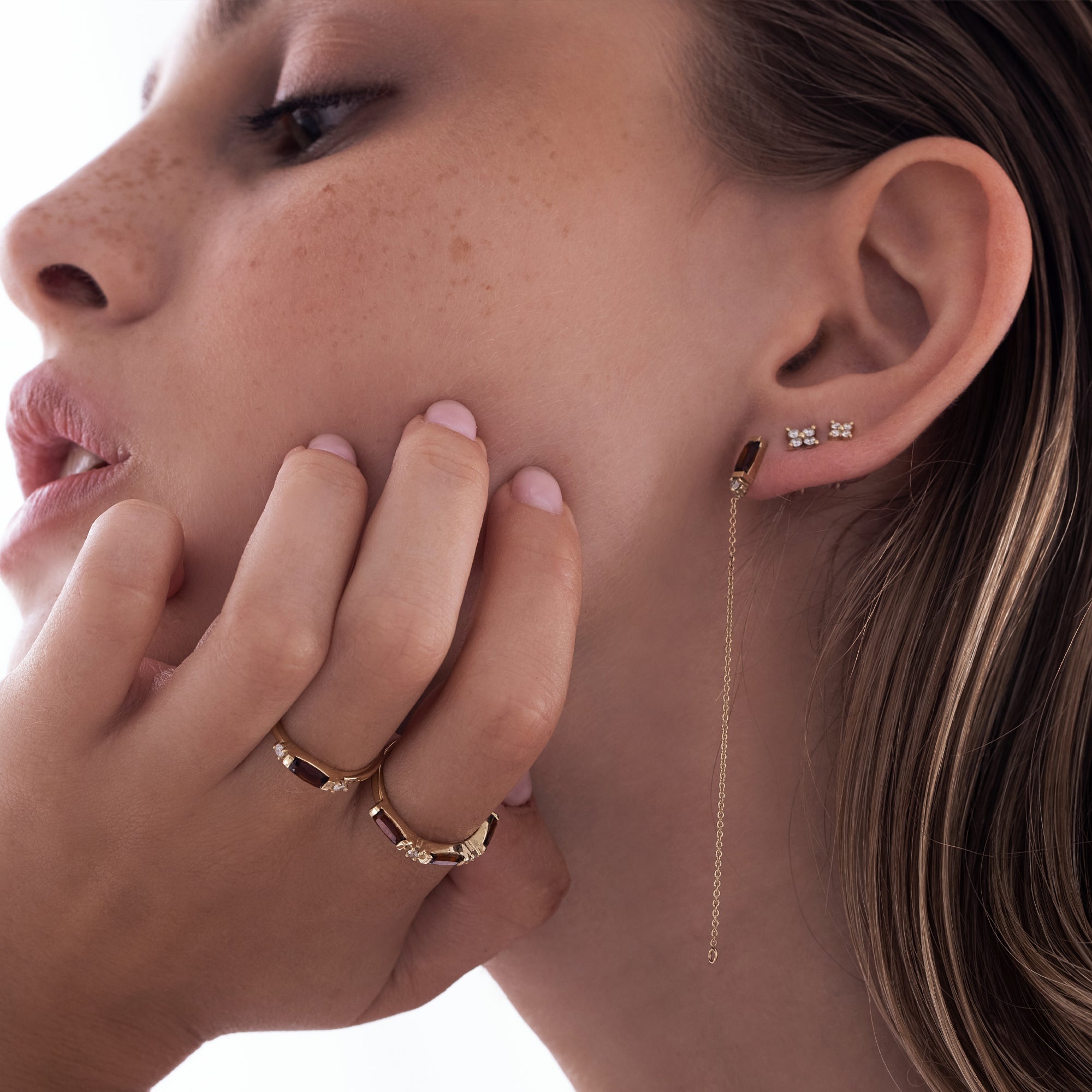 Tight gold earrings set with 4 white diamonds