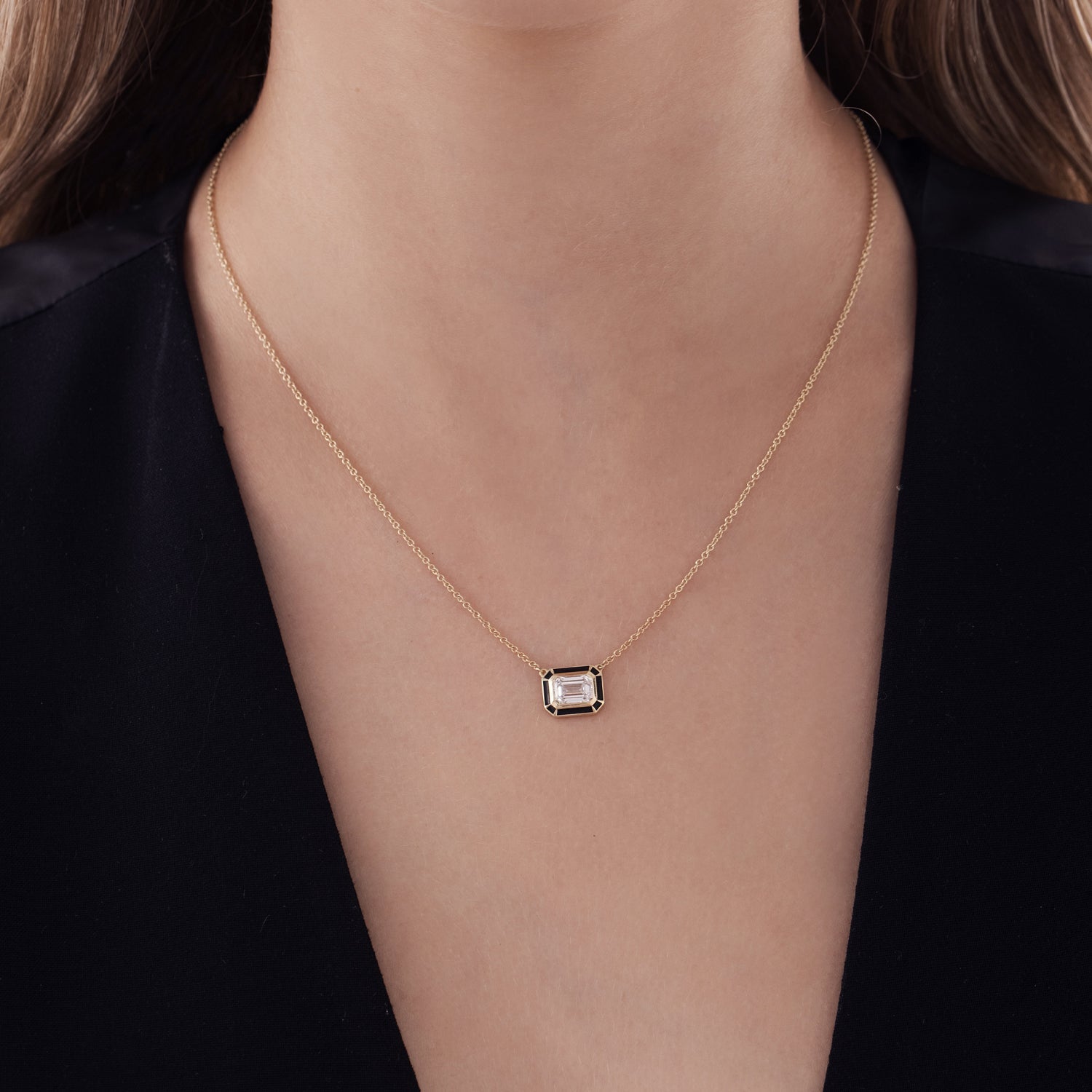 A special classic gold necklace with a 1 carat emerald cut laboratory diamond in a special enamel frame