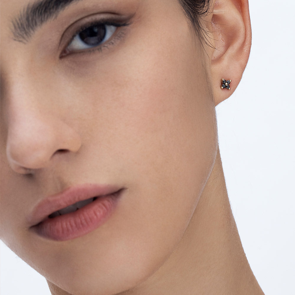 Tight gold earrings studded with 4 black diamonds