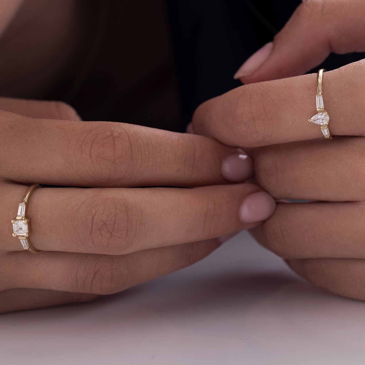 A geometric gold ring set with drop-cut natural diamonds and claws