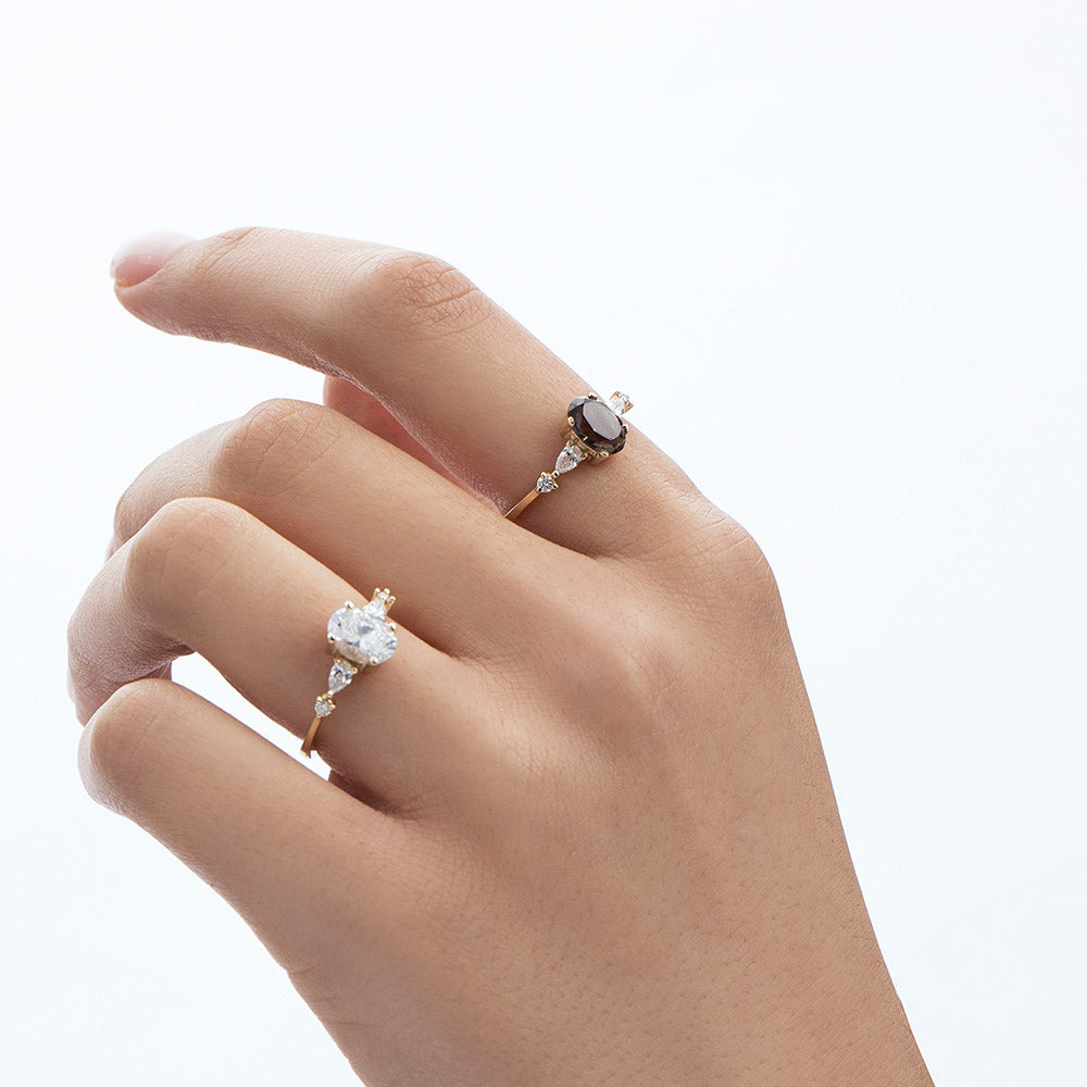 A gold ring set with smoky quartz and drop and round cut diamonds