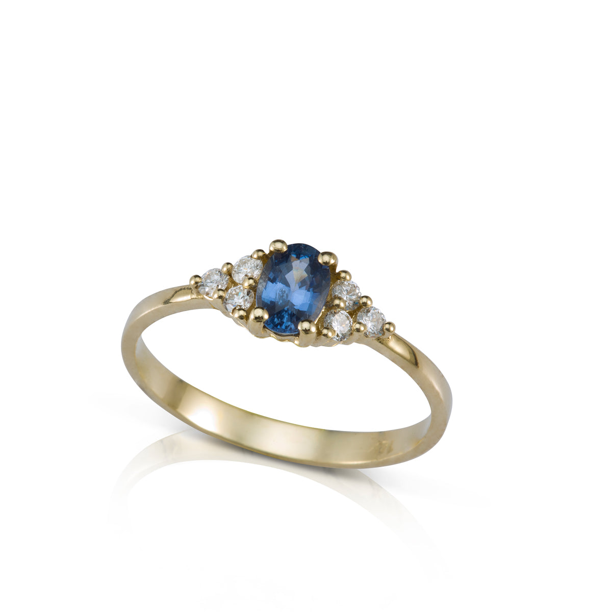 An engagement ring set with an oval-shaped sapphire and 6 sided diamonds