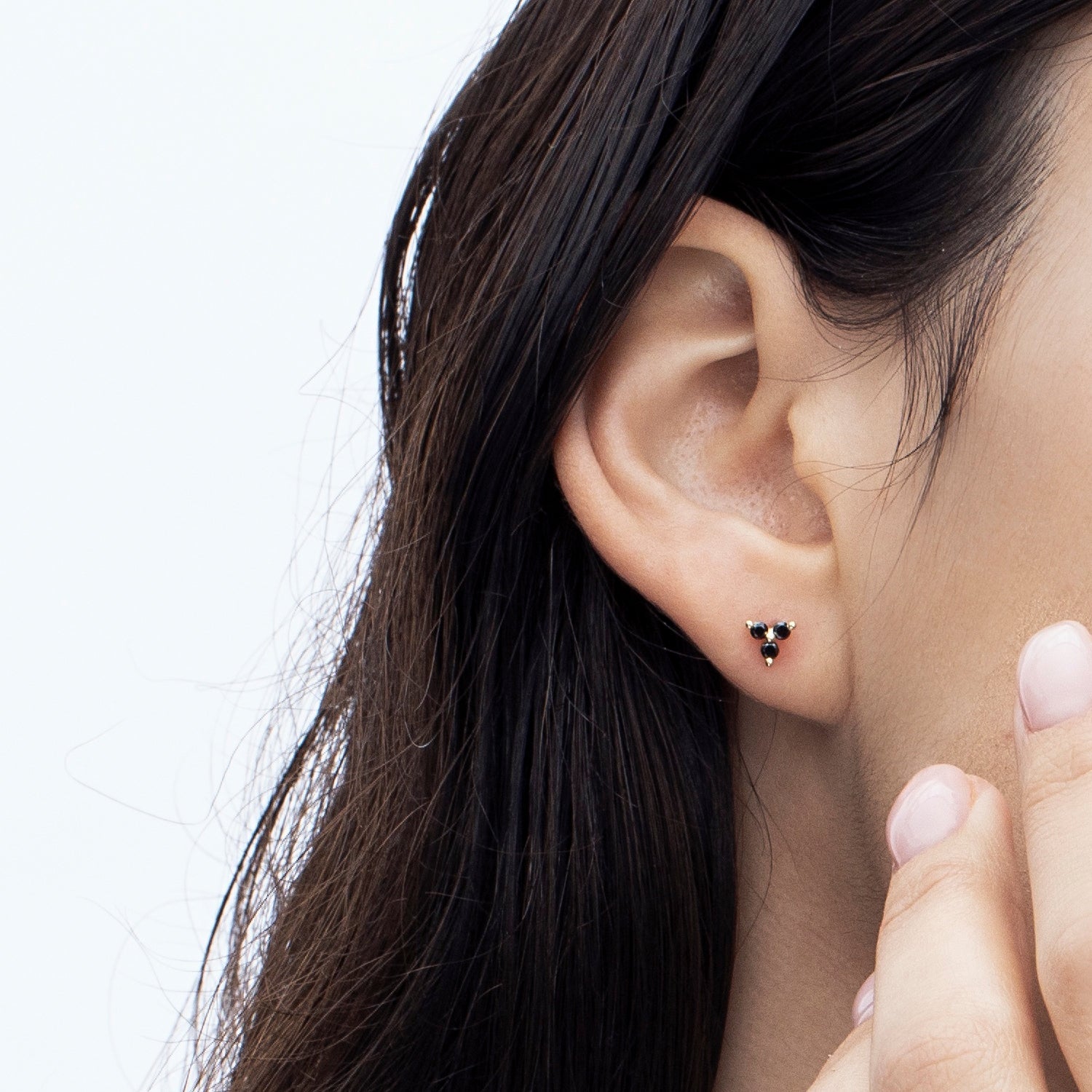 Tight gold earrings set with 3 black diamonds