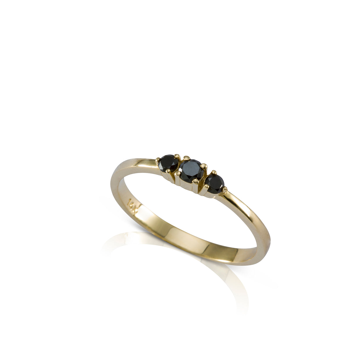 A gold ring set with three black diamonds