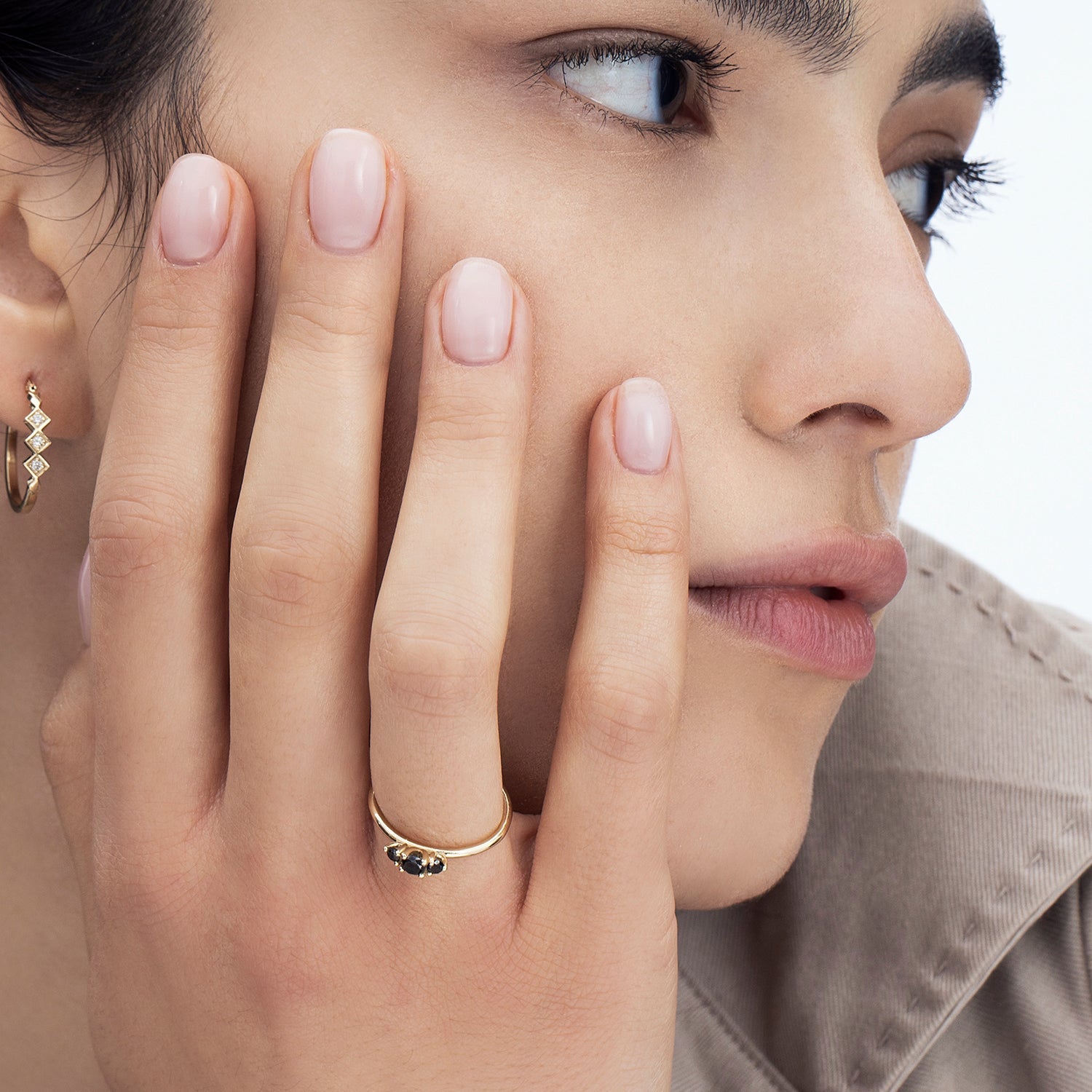 A fine gold ring set with three black diamonds