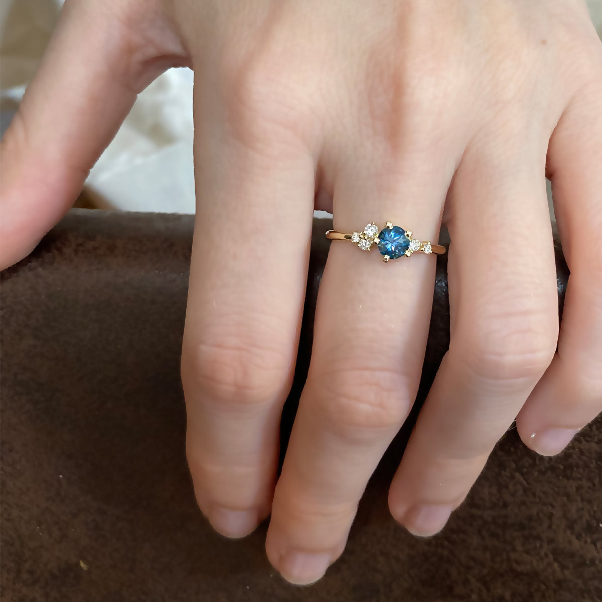 An engagement ring set with London blue topaz and small one-centimeter diamonds