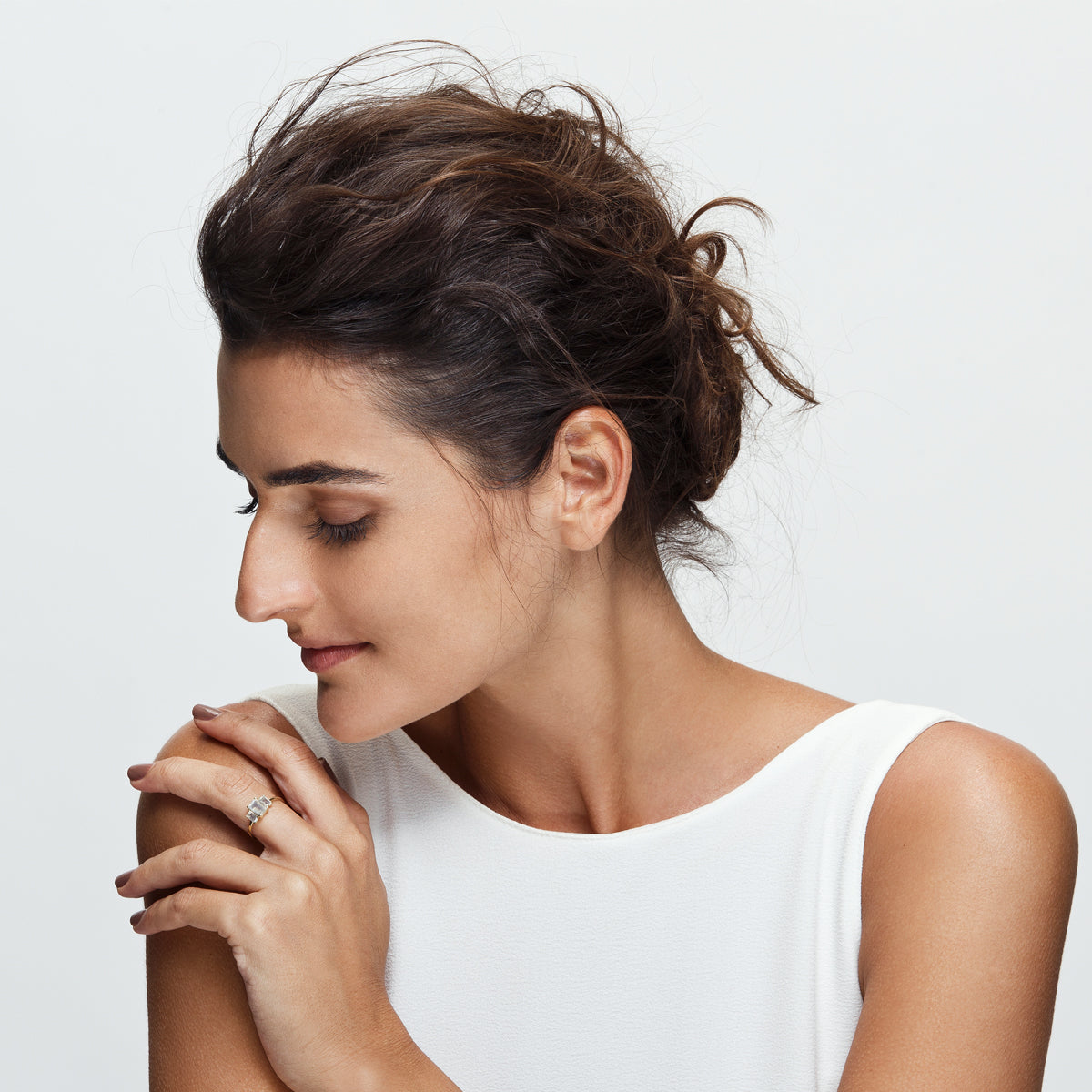 A gold ring inlaid with 3 moonstone stones in a rectangular cut
