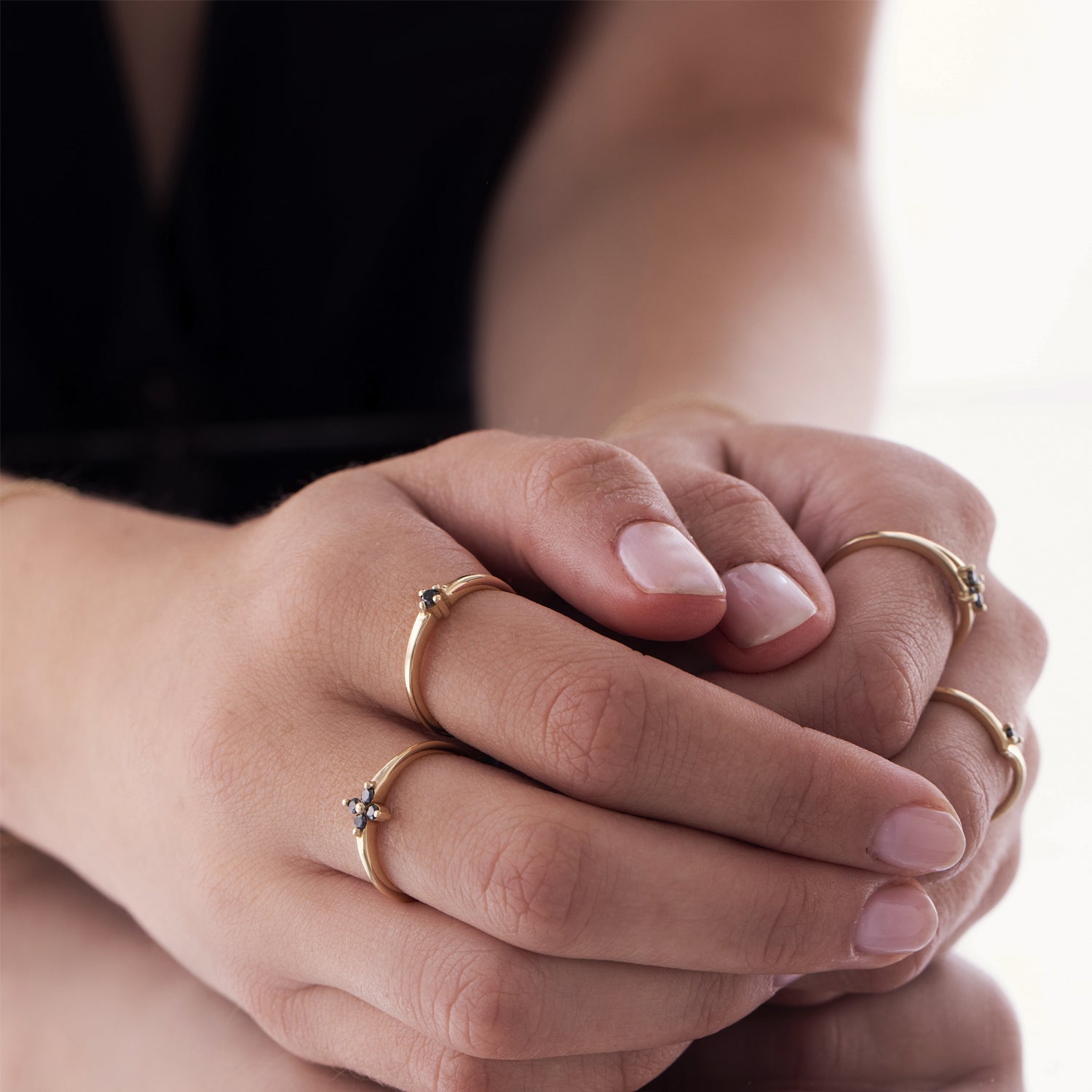 Delicate gold ring with black diamonds in the shape of a flower