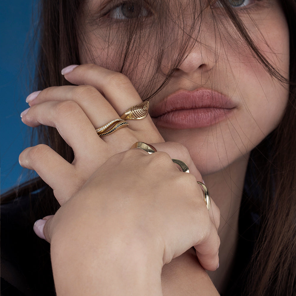 A thick wave ring set with a row of black diamonds