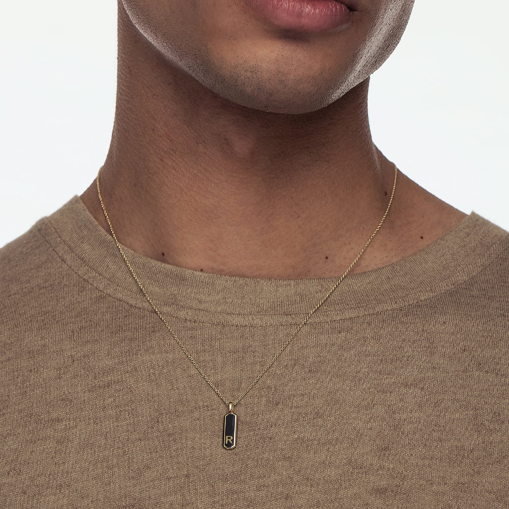 Gold necklace with two-sided narrow letter pendant combined with enamel