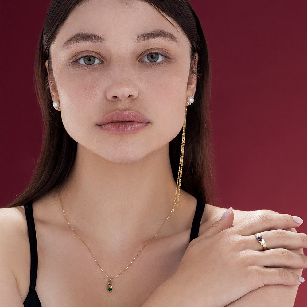Gold necklace with fish pendant inlaid with tourmaline