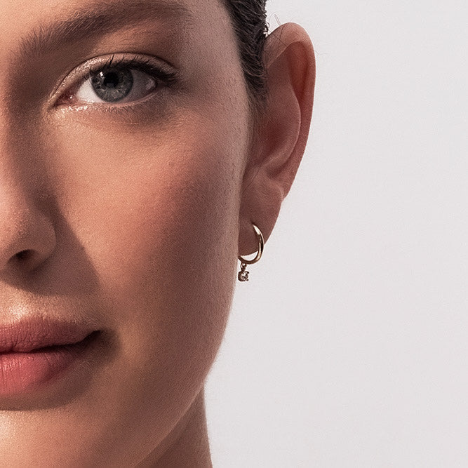 Gold hoop earrings with 20 point diamonds inlaid with teeth