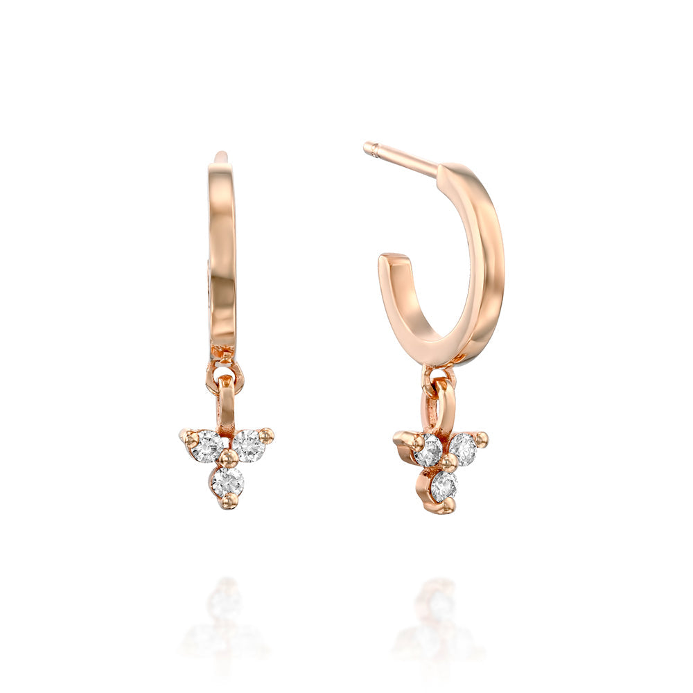 Gold hoop earrings with a triangular pendant with 3 white diamonds
