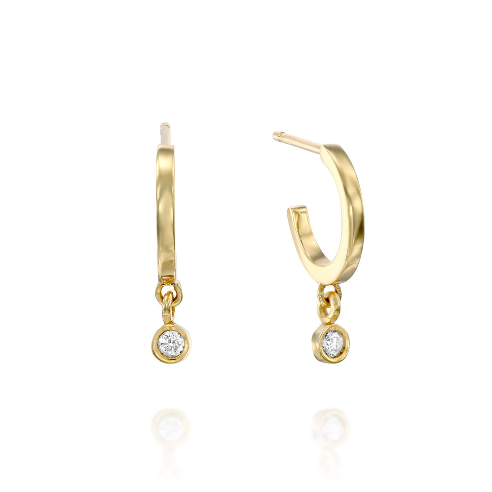 Small gold hoop earrings with a 4-point diamond pendant in a gold frame