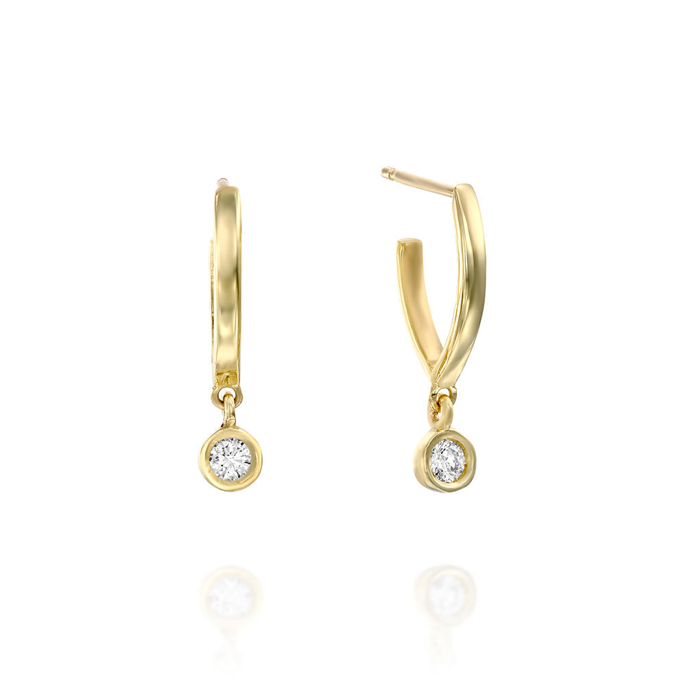 Special elongated hoop earrings, with a swinging diamond in a gold frame