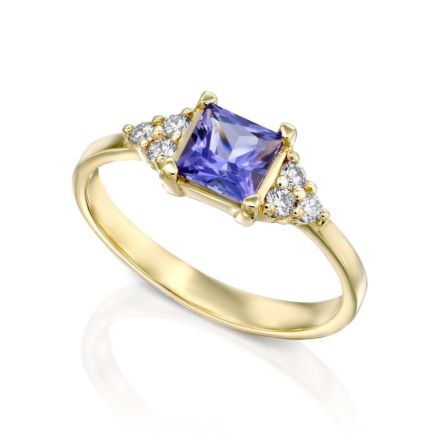 A gold ring set with Tanzanite Princess and 6 sided diamonds