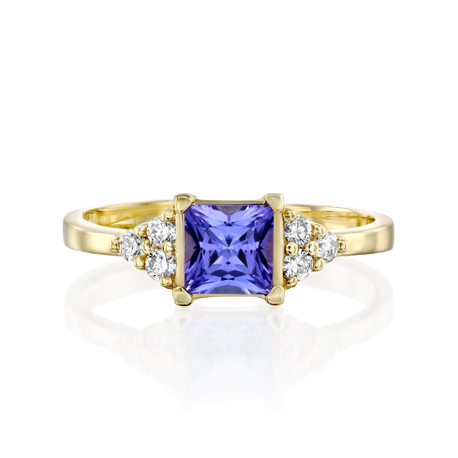 A gold ring set with Tanzanite Princess and 6 sided diamonds