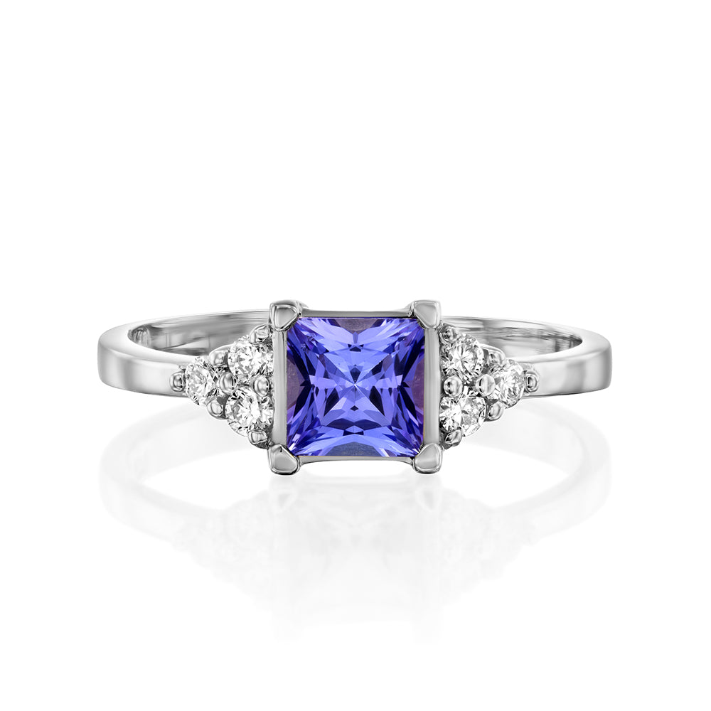 A gold ring set with Tanzanite Princess and 6 sided diamonds
