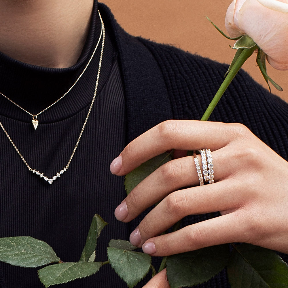A gold ring set with 7 laboratory diamonds weighing 15 points per diamond