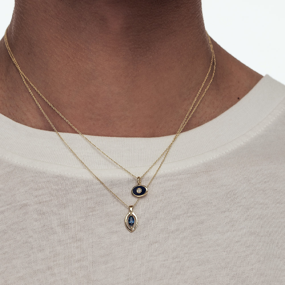A gold chain with a modern evil eye pendant for men, inlaid with a marquise-cut sapphire