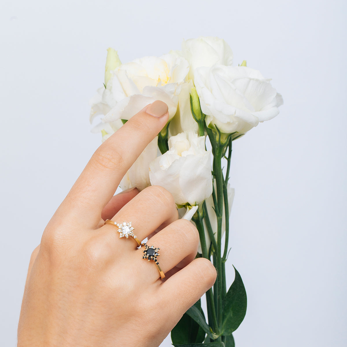A black diamond star ring, with a central brilliant cut diamond