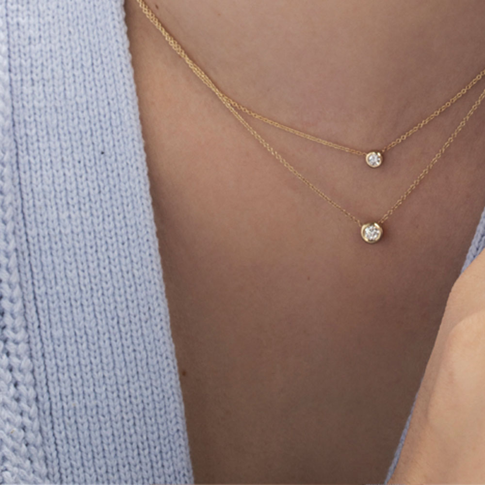 Gold necklace with a diamond pendant in a cup setting, attached to the chain on both sides, 0.15ct diamond