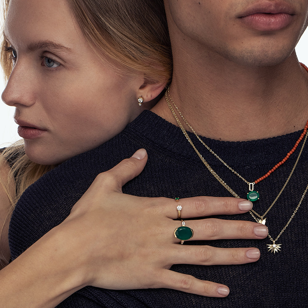 Open gold and diamond ring. A ring set with a laboratory diamond weighing 30 points and a natural emerald.