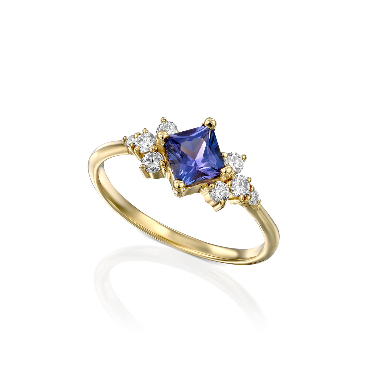 A gold ring set with princess tanzanite and round diamonds