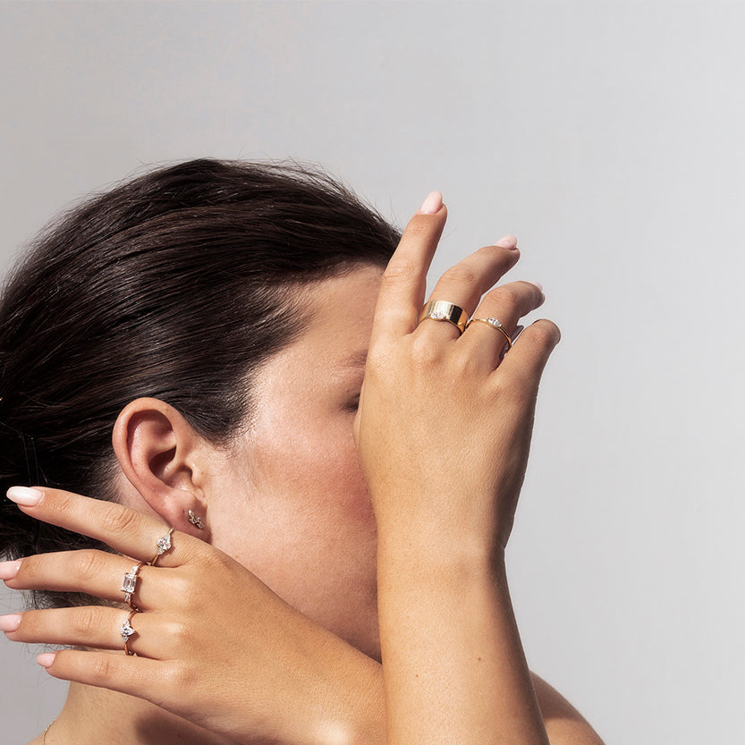 Close-up gold earrings in the shape of leaves set with marquise-cut diamonds