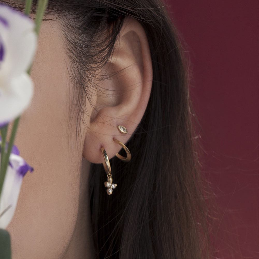Small attached gold hoop earrings in the shape of a drop