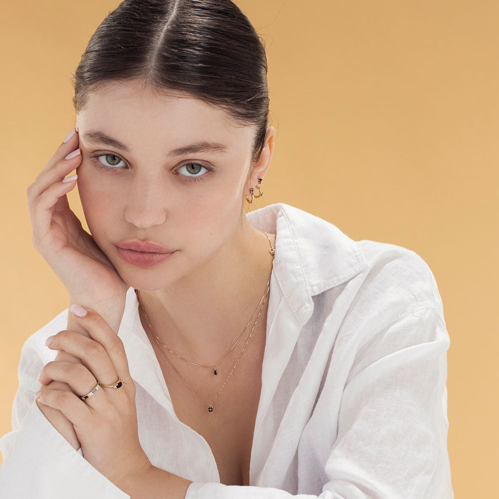 Attached gold earrings and special black diamonds in a marquise and circle cut