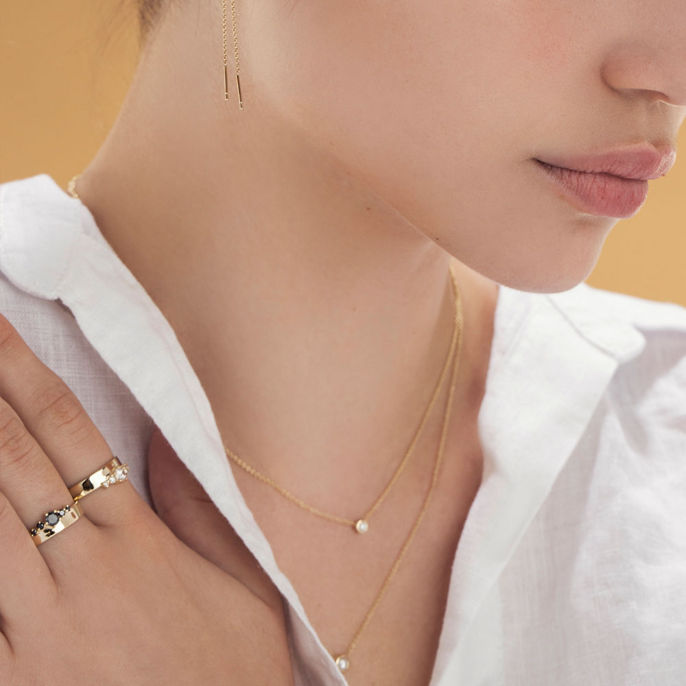 A wide gold ring with a special asymmetrical setting of black diamonds