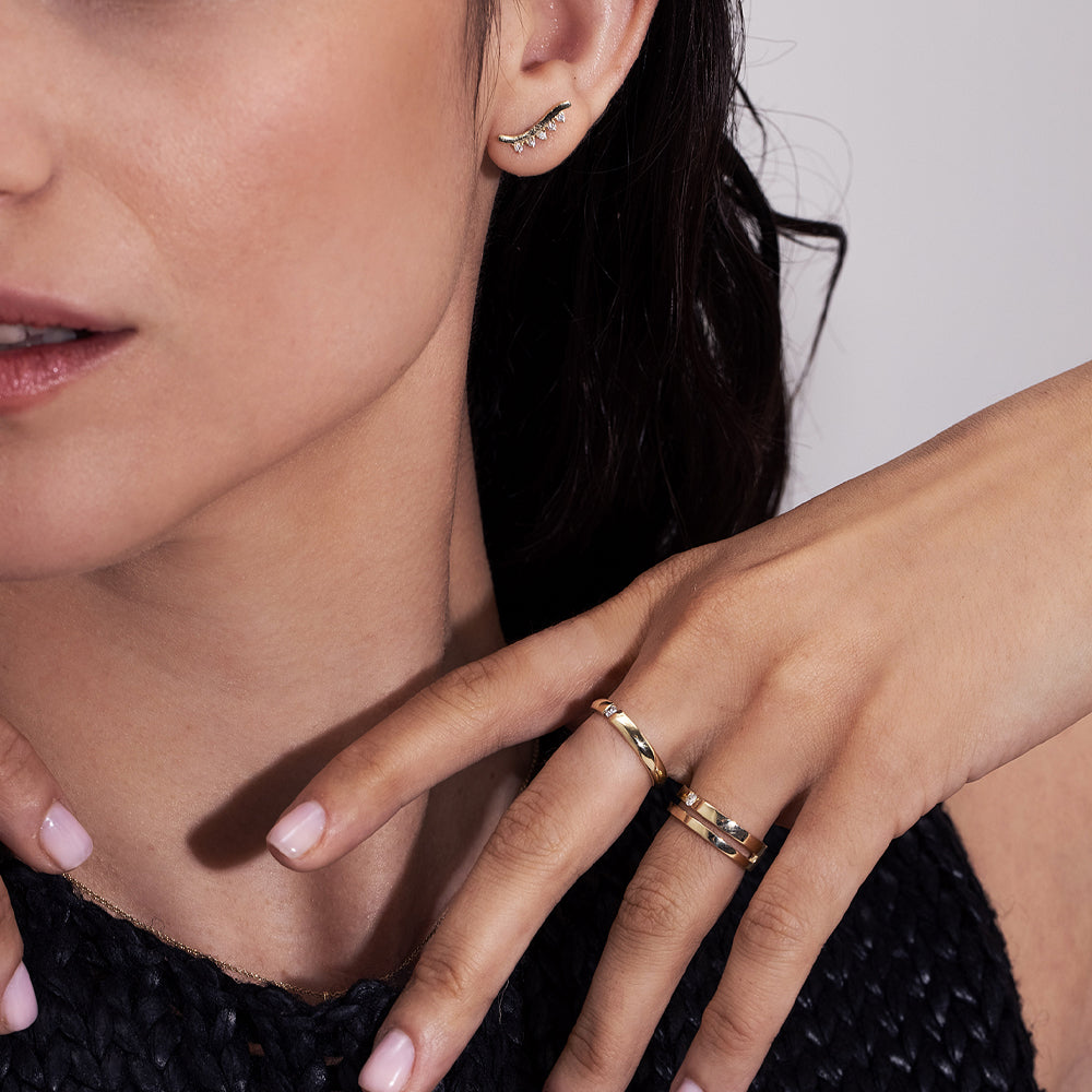 A gold ring set with a round diamond weighing 5 points