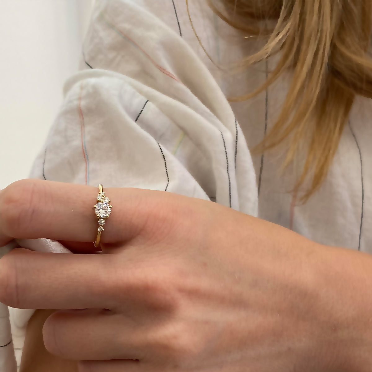 An engagement ring set with a half carat diamond and small asymmetric diamonds