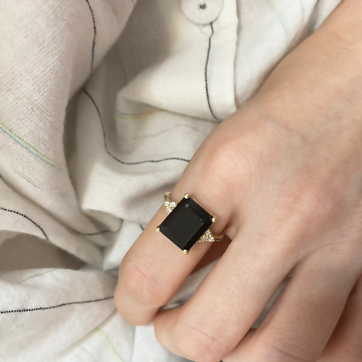 Engagement ring studded with rectangular black onyx and 6 sided diamonds