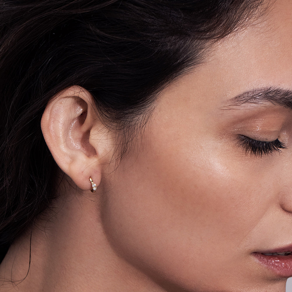 Small gold hoop earrings set with 2 diamonds