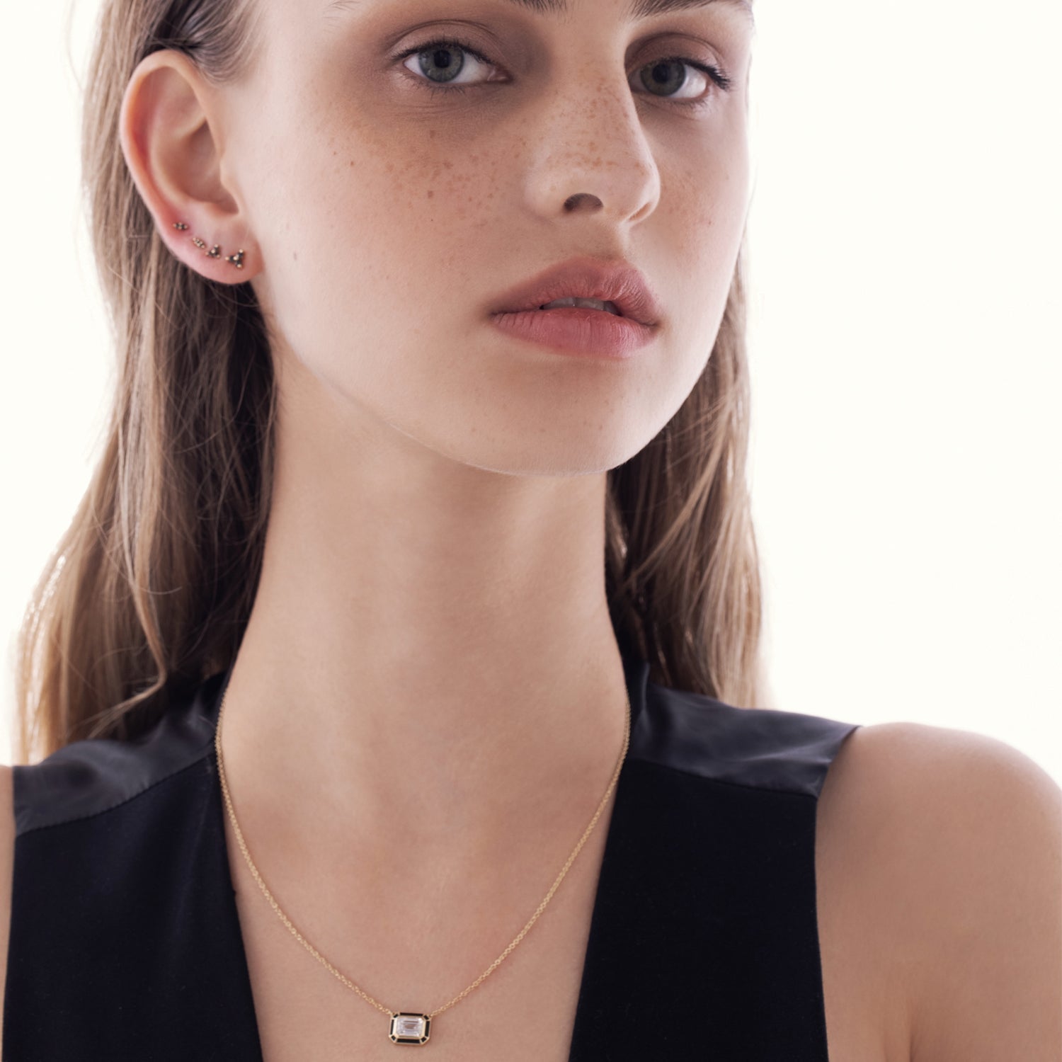 A special classic gold necklace with a 1 carat emerald cut laboratory diamond in a special enamel frame