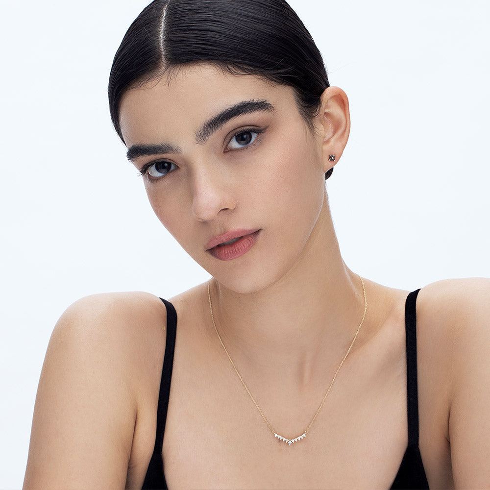 Tight gold earrings studded with 4 black diamonds