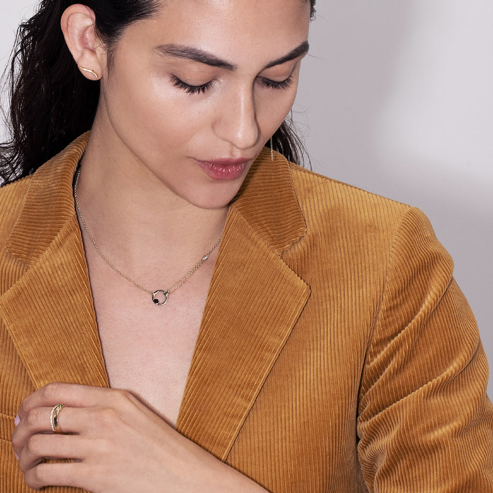 A thick, asymmetric and special gold chain, with a modern and impressive design. Set with tourmaline and diamond