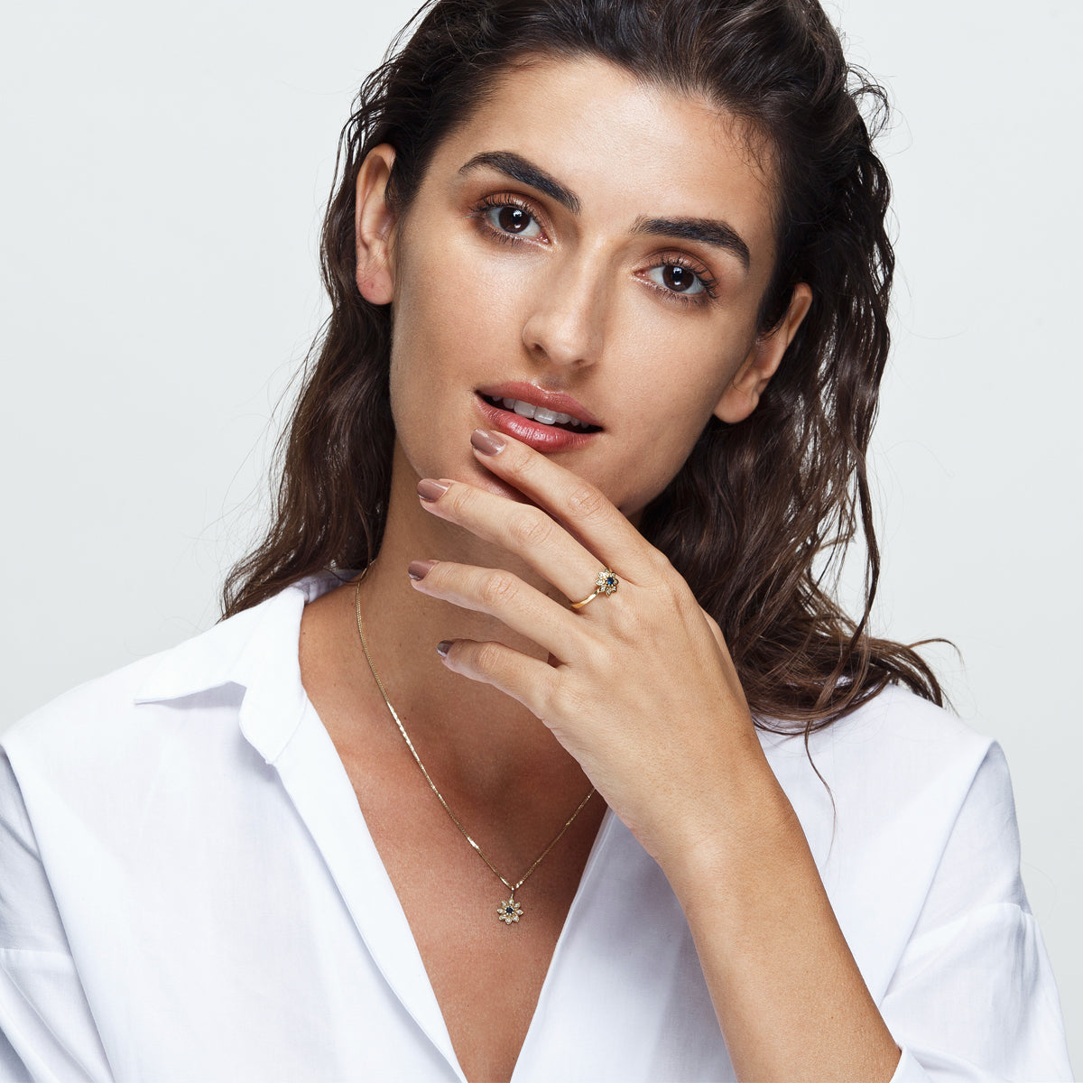 Gold necklace with a flower studded with diamonds and sapphires