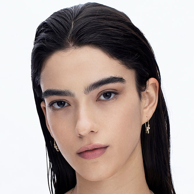 Hanging gold earrings studded with laboratory diamonds of varying sizes