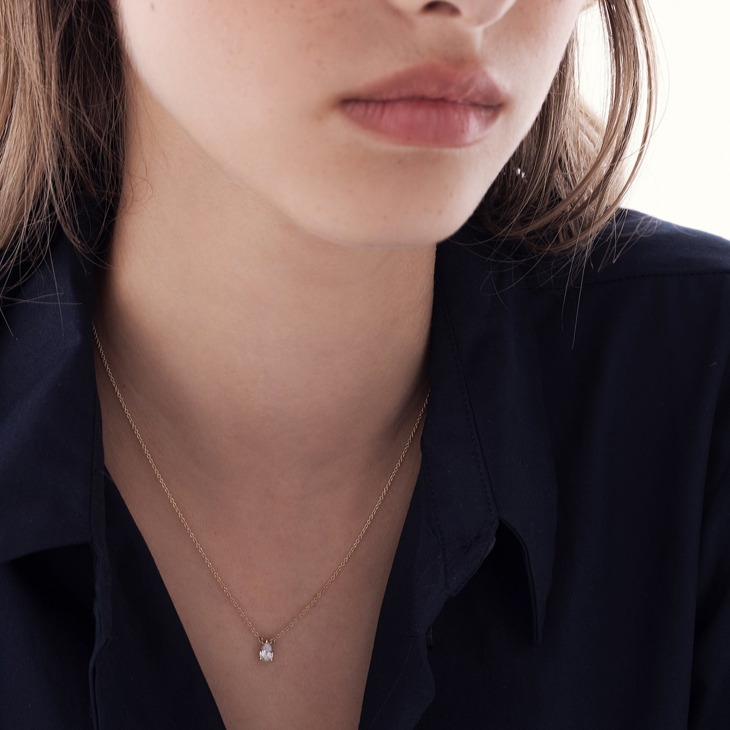 A classic gold chain set with a drop-cut lab diamond