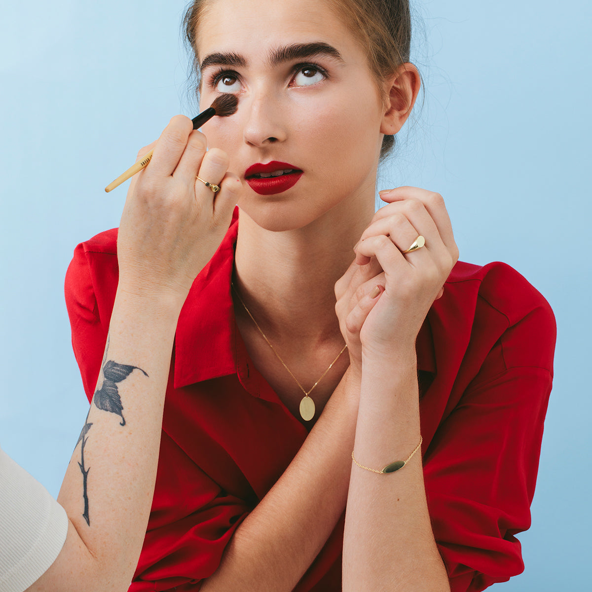 A gold bracelet with an oval engraved name