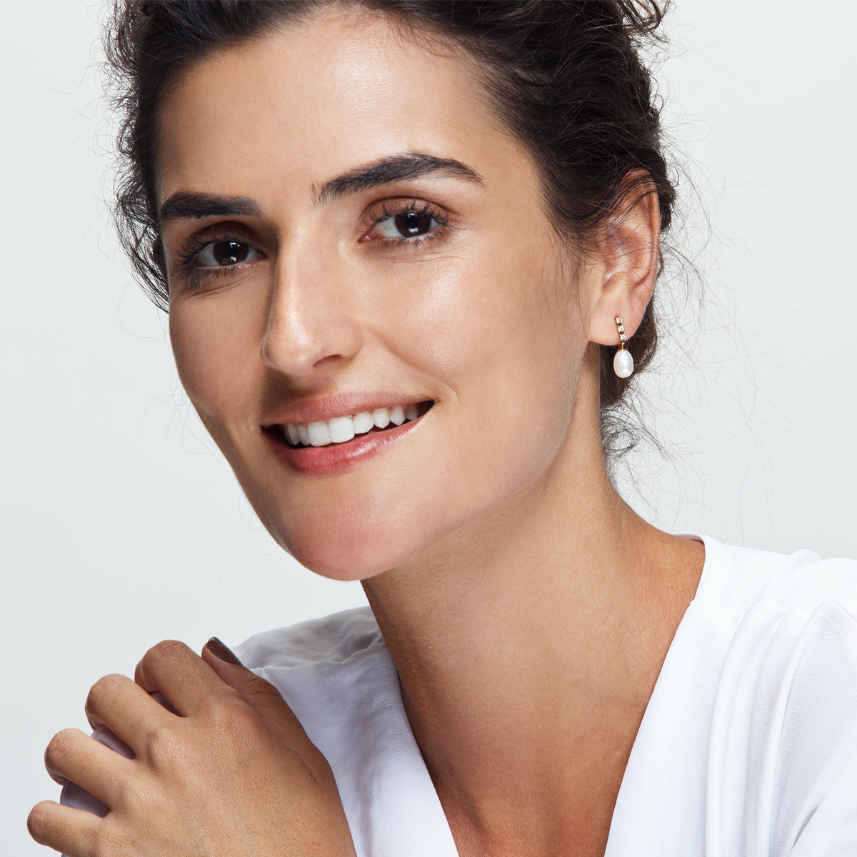 Diamond and pearl earrings hanging from gold