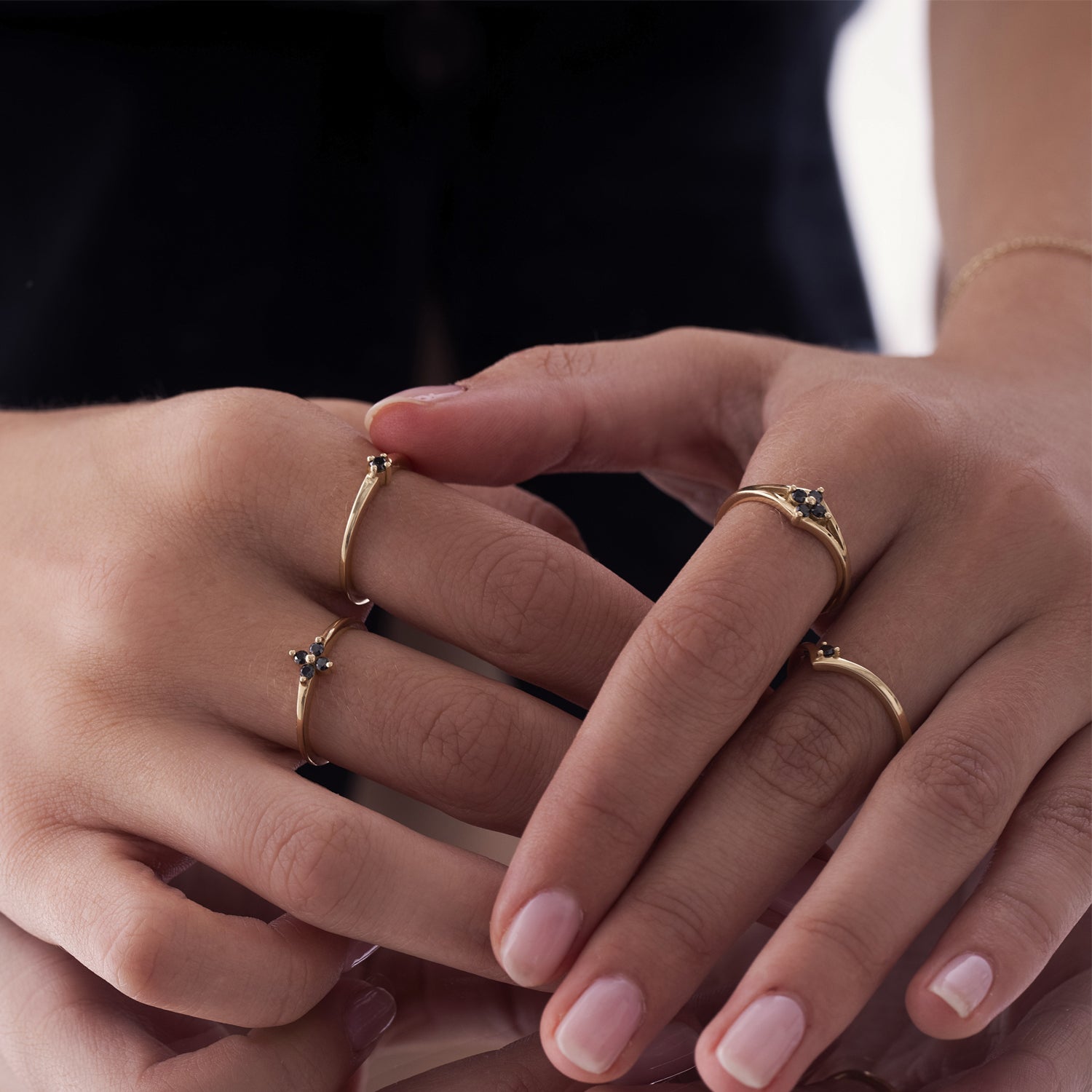 Delicate gold ring with black diamonds in the shape of a flower